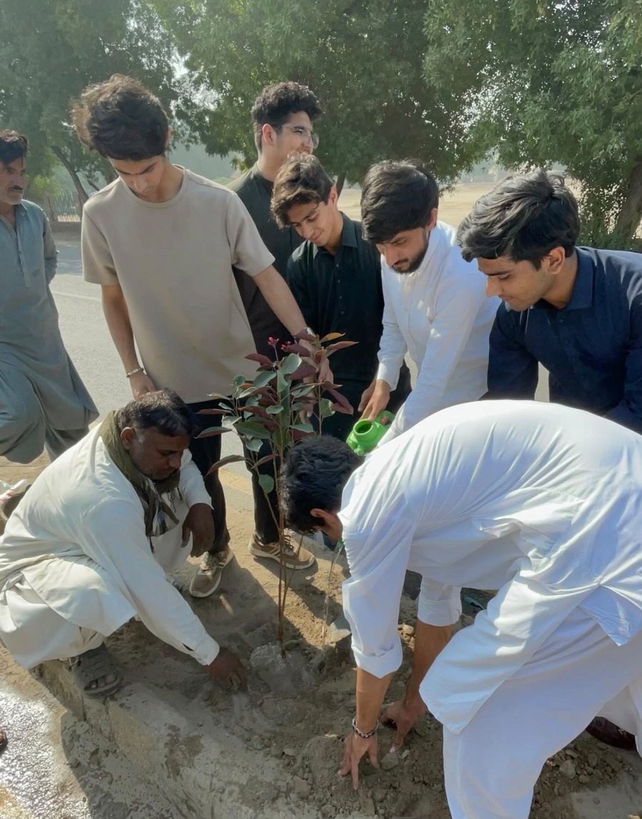 Volunteers planting a sapling during a Khidmate-e-Khalq Trust plantation drive